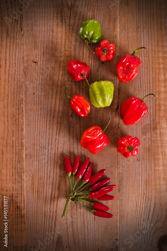Fototapeta Naklejka Na Ścianę i Meble -  Red hot chili peppers on wooden table.