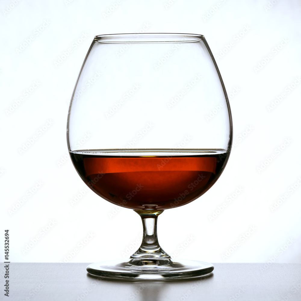 glass of brandy and chocolate pieces glass of brandy and chocolate pieces