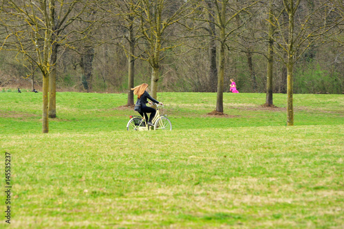 Blonde girl on bicycle. Open air life. Long hair in the wind. © habilis123
