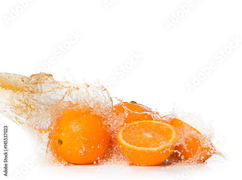 Water splash with orange and lime isolated on white background. Splash motion with fruits. Abstract object 