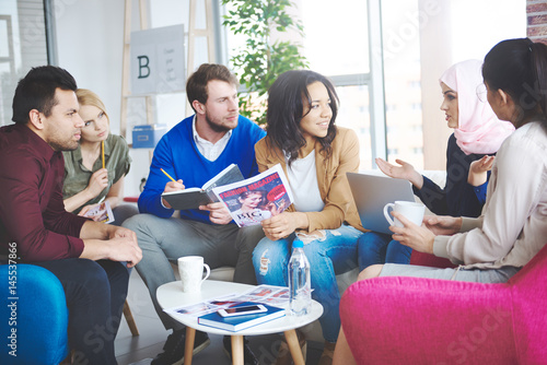 Photography of people discussing abot fashion magazine photo