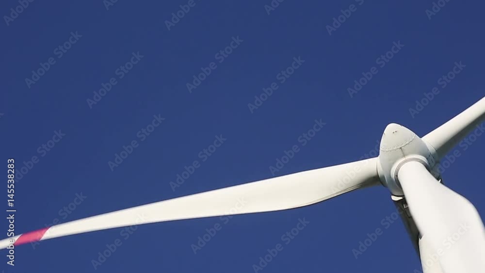 Wind turbine on blue sky background. Audio included. Wind turbine on blue sky background. Audio included.