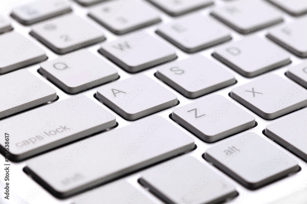 White modern keyboard close-up of buttons White modern keyboard close-up of buttons