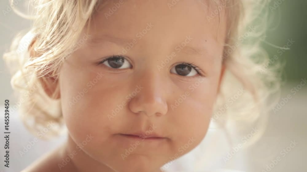 Close-up portrait of beautiful little girl with a cup of tea Close-up portrait of beautiful little girl with a cup of tea