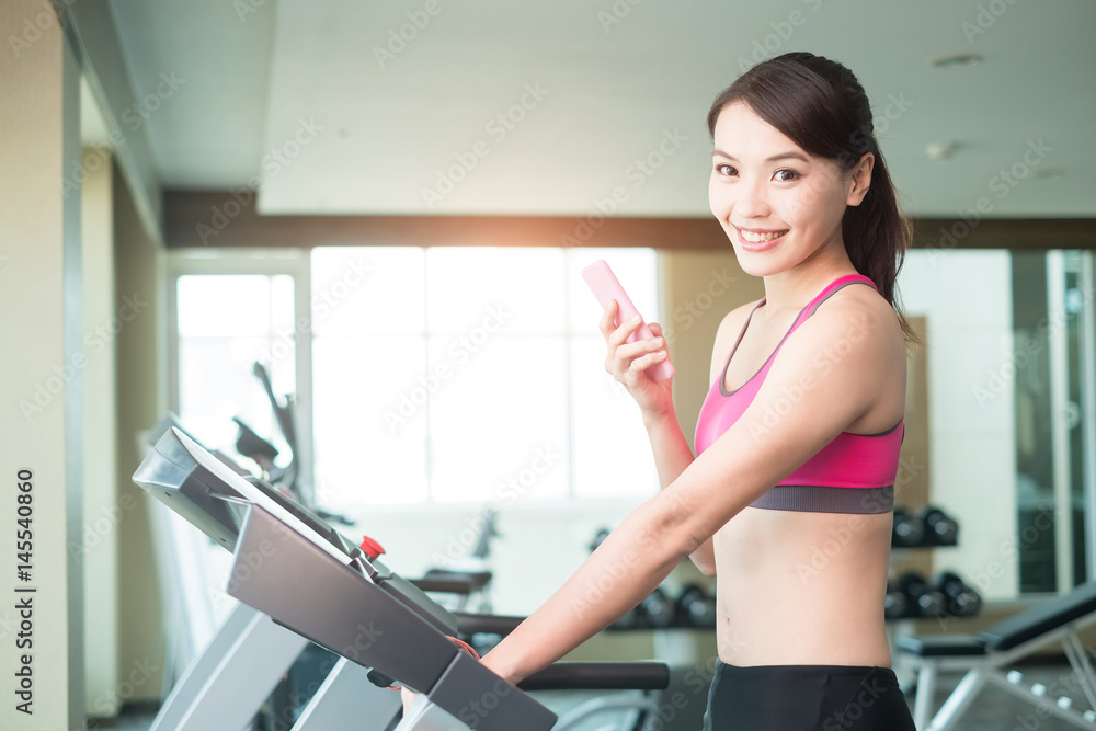 Fototapeta premium woman stand on treadmill