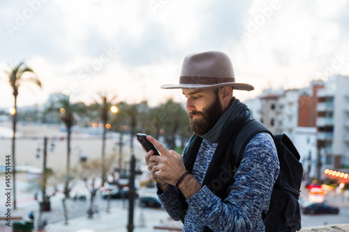 Male traveler using phone photo