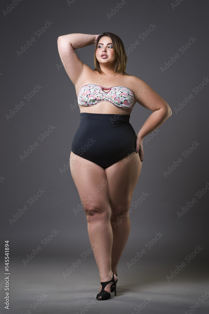 Plus size fashion model in sexy swimsuit, young fat woman on gray  background, overweight female body Stock Photo | Adobe Stock