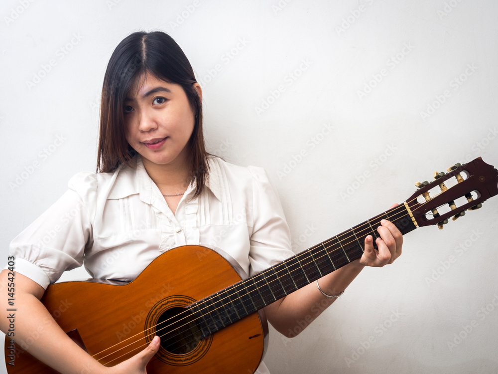 Beautiful Young Asian - Chinese Woman Playing Guitar Beautiful Young Asian - Chinese Woman Playing Guitar