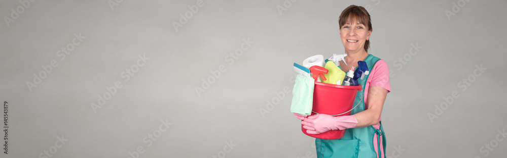 Maid holding a bucket with cleaning equipment Maid holding a bucket with cleaning equipment
