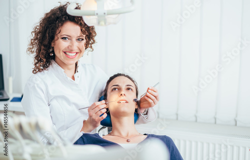 Portrait of a female dentist and her patient.