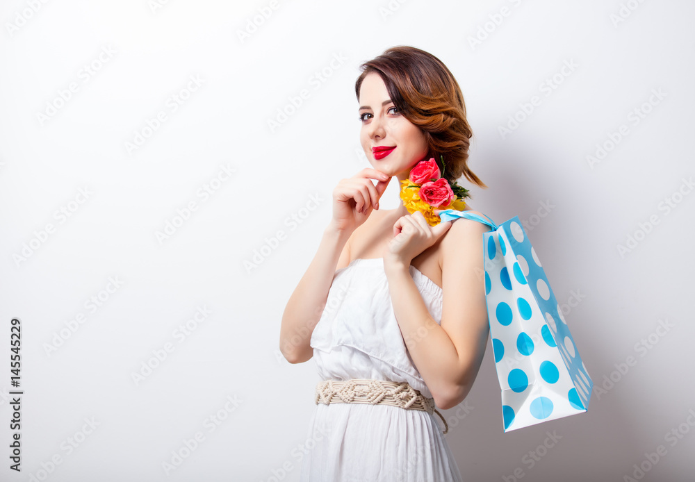 portrait of beautiful young woman with dotted shopping bag on the wonderful studio background portrait of beautiful young woman with dotted shopping bag on the wonderful studio background