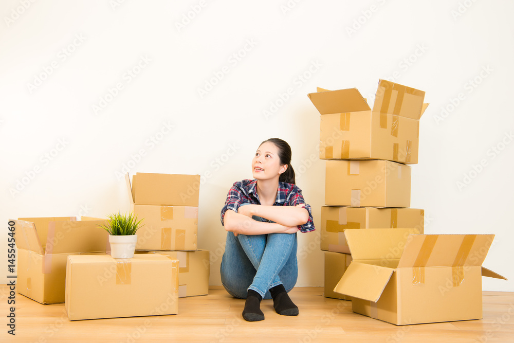 Young woman with boxes dreaming Young woman with boxes dreaming