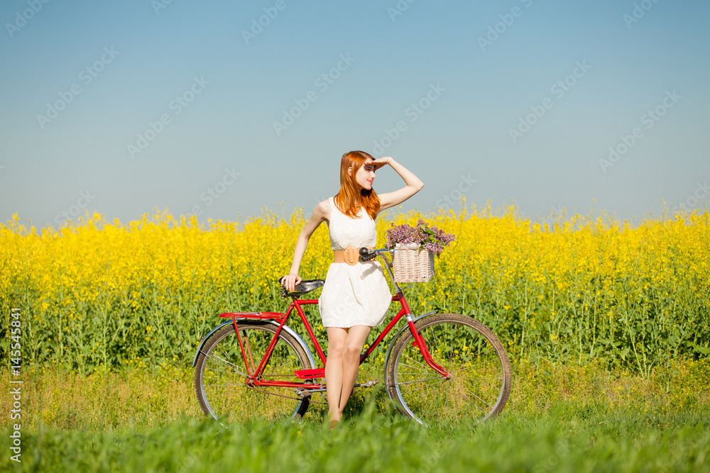photo of beautiful young woman with bicycle on the wonderful flower field background photo of beautiful young woman with bicycle on the wonderful flower field background