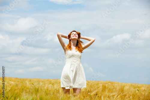 portrait of beautiful young woman on the wonderful wheat field background