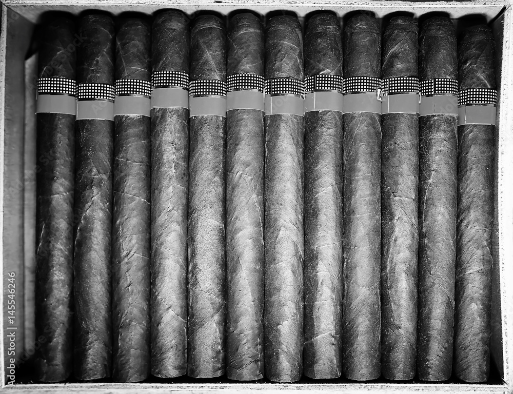 Retro styled photo of large box of Cuban cigars on a wooden table Retro styled photo of large box of Cuban cigars on a wooden table