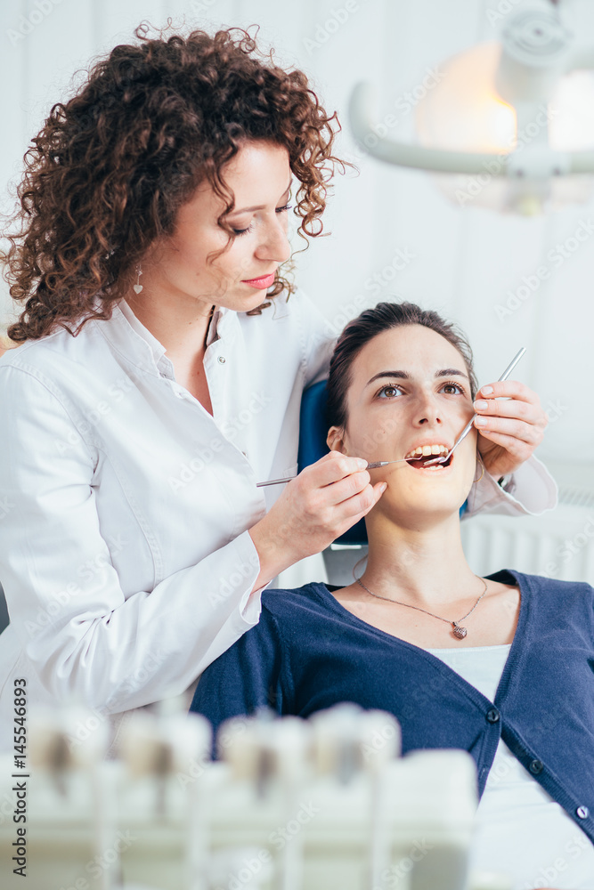 Female dentist working in her dentist office. Female dentist working in her dentist office.