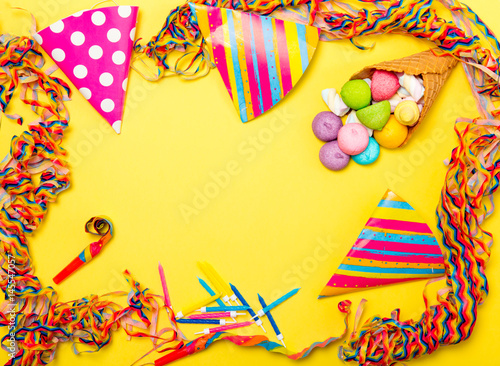 photo of beautiful set for celebrating Birthday and marshmallows in waffle cone on the wonderful yellow studio background