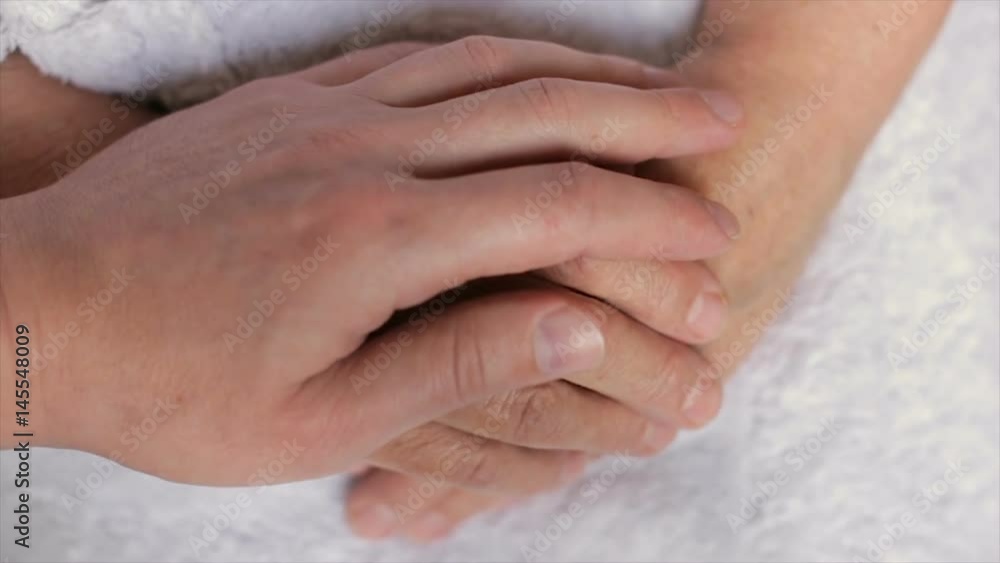 A man caresses a wrinkled woman's hand,full hd video A man caresses a wrinkled woman's hand,full hd video