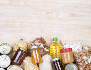 Food donations on wooden background, top view with copy space