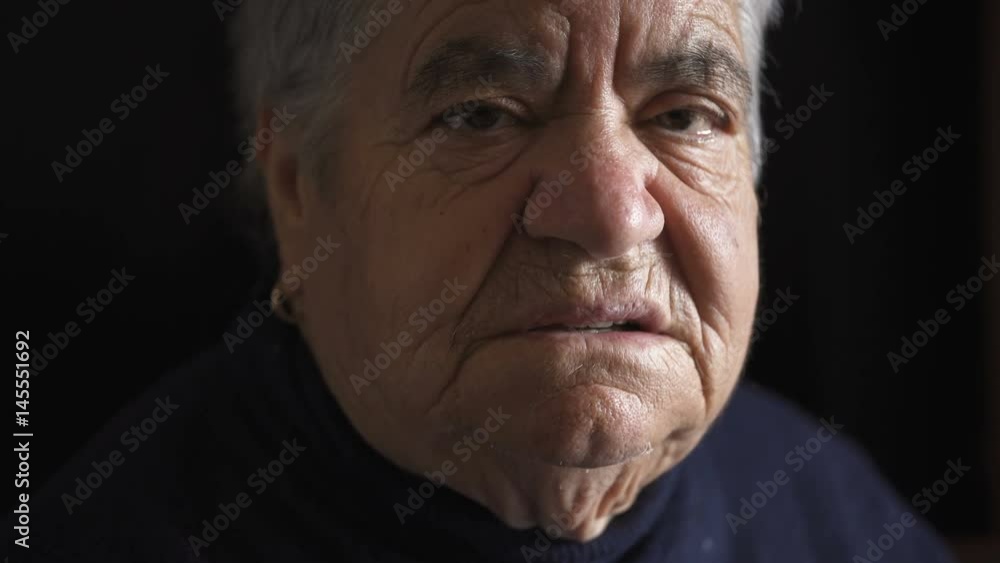 Angry and serious old woman looks at the camera Angry and serious old woman looks at the camera