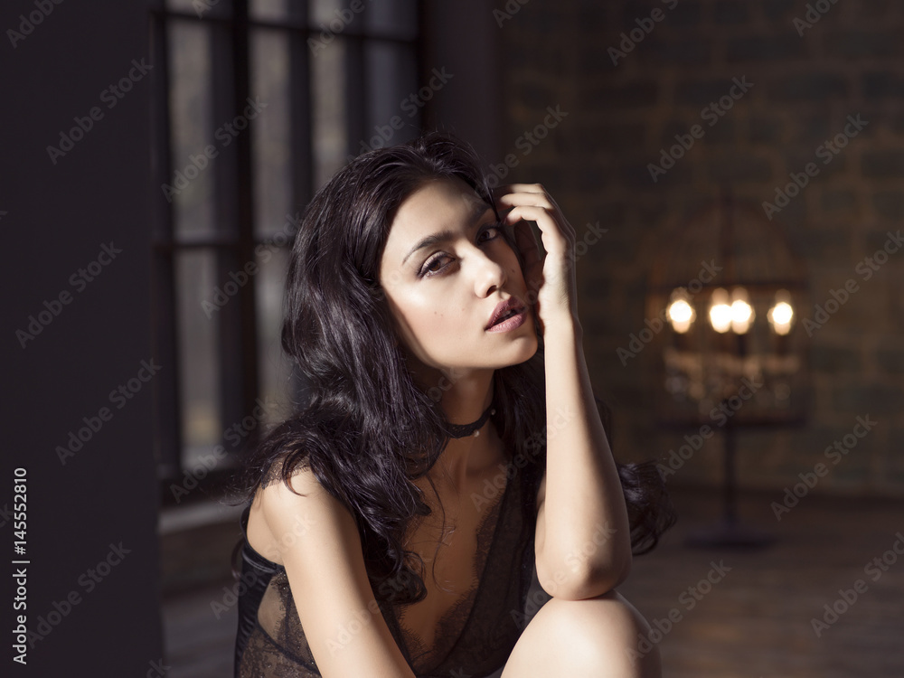 Model wearing sexy bodysuit posing in a interior. Model wearing sexy bodysuit posing in a interior.