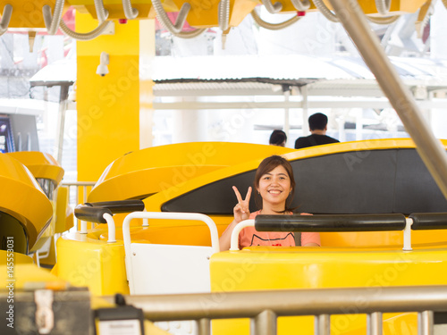 Canvas Print Happy Young Asian Play Spinning Rides