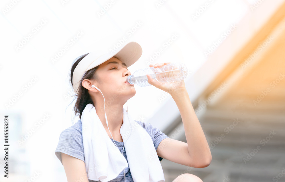 Fitness athlete woman drinking water after work out exercising