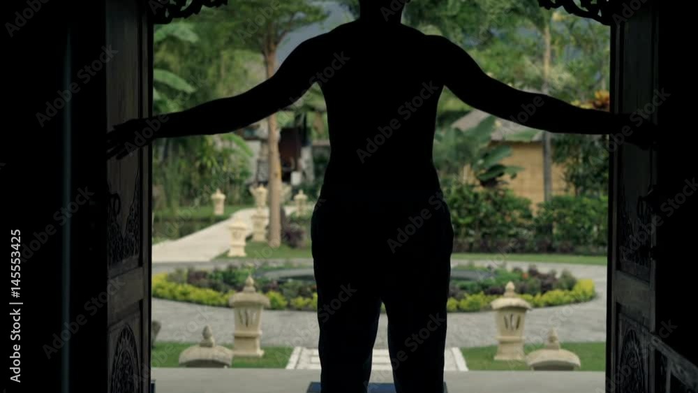 Young man opening door and walking out on porch in country house
Young man opening door and walking out on porch in country house