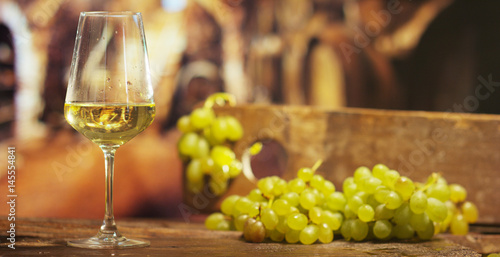 sommelier in vineyard pouring italian white wine in glass in slow motion