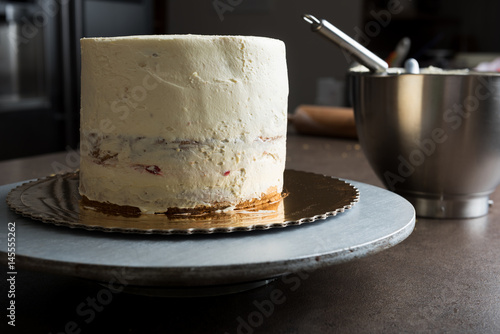 Fotografie, Tablou Delicious sponge cake filled with butter cream and decorated with frosting