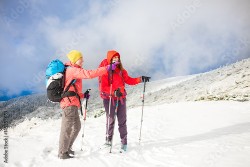 Two girls in the mountains in winter.