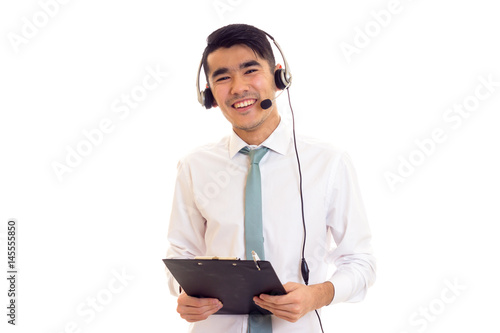 Young man using headphones and holding folder photo