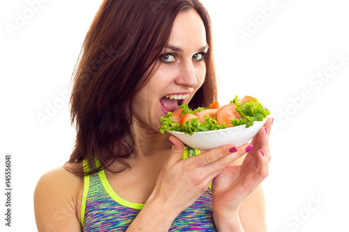 Sportive woman holding salad 