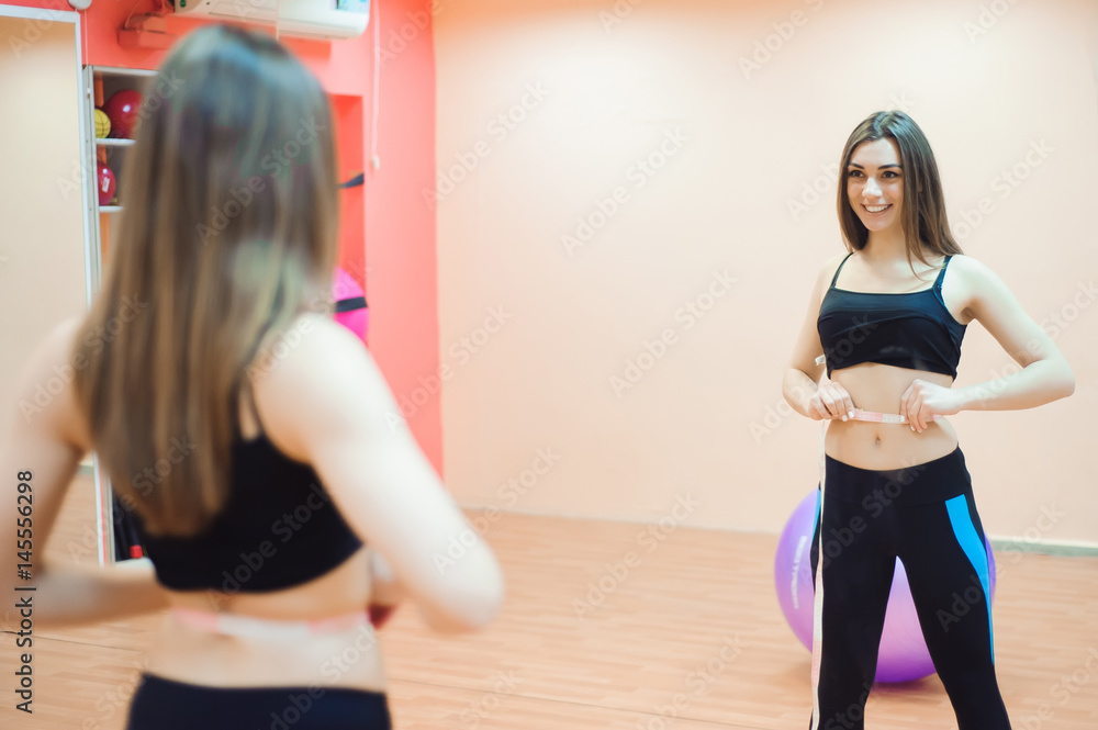 custom made wallpaper toronto digitalYoung slim woman measuring waist using the tape measure.