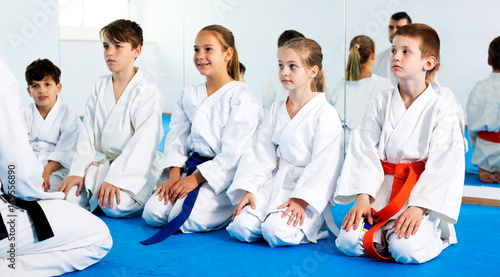 Obraz na płótnie Children enjoying their trainings with coach at karate
