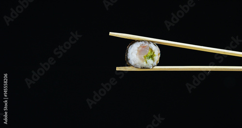 Macro shot of sushi, sashimi, uramaki and nighiri. typical Japanese dish consisting of rice, salmon or tuna,shrimp and fish eggs soaked in soy. Concept: Japanese restaurant, sushi, oriental tradition.