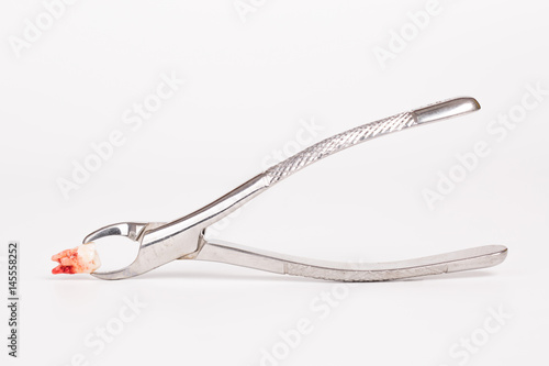 Dental tools and remove tooth on white background