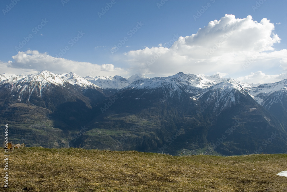 Mountain landscape of the Swiss Alps on a beautiful sunny day and clouds in the spring, after a snowfall in the high mountains, Alps, Switzerland