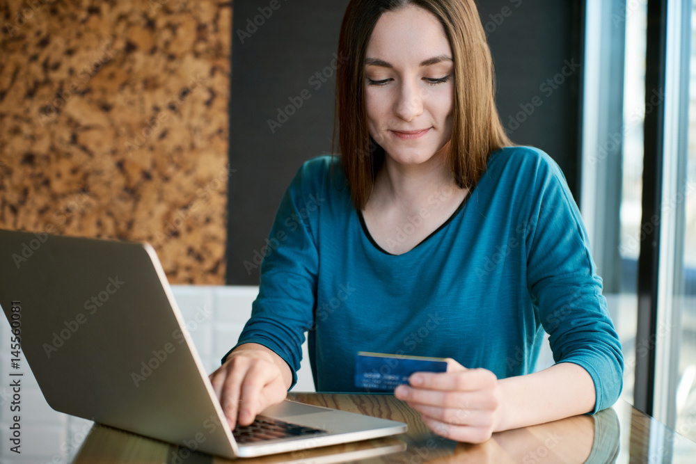 Young woman making online payment via laptop Young woman making online payment via laptop