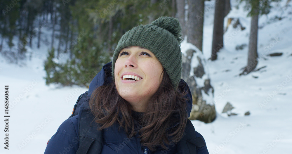 slow motion of A girl walks through the woods and in the snow, breathe pure air, smiles in the nature of the mountain, is walking with hiking backpack.Concept:relaxation, hiking, love, purity, freedom slow motion of A girl walks through the woods and in the snow, breathe pure air, smiles in the nature of the mountain, is walking with hiking backpack.Concept:relaxation, hiking, love, purity, freedom