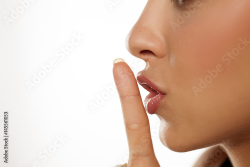 Close up finger in front of lips ... concept of silence
