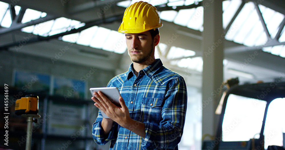 on a construction site, a worker or an engineer or architect controls the design and construction of the building with high energy savings. Concept: construction, worker, engineering, design. on a construction site, a worker or an engineer or architect controls the design and construction of the building with high energy savings. Concept: construction, worker, engineering, design.