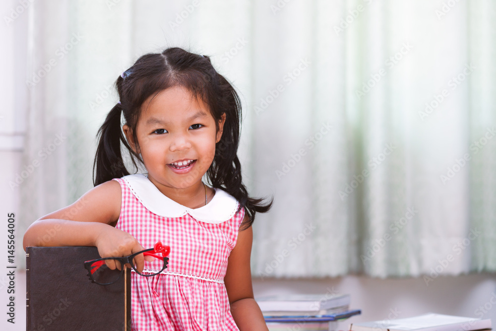 Portrait of happy asian little girl with book Portrait of happy asian little girl with book
