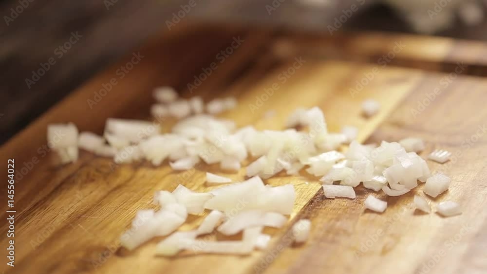 White Onions - Puttting Chopped White Onion In A Bowl - Side Angle White Onions - Puttting Chopped White Onion In A Bowl - Side Angle