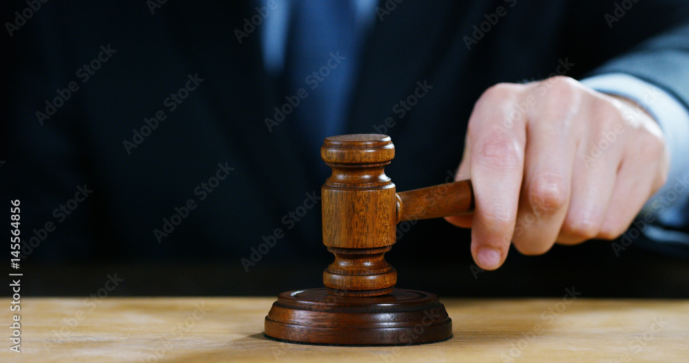 hand shake, auction scene of lawyers or notaries with gavel judge for the insurance compensation or criminal cases. concept of law and lawyer, judiciary and legislature applied to the democratic law. hand shake, auction scene of lawyers or notaries with gavel judge for the insurance compensation or criminal cases. concept of law and lawyer, judiciary and legislature applied to the democratic law.