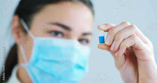 woman hand of a hospital medical expert shows the pill to be taken by patient in slow motion. 