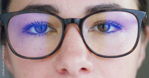 A woman watches with a futuristic look with glasses. augmented reality in holography. 