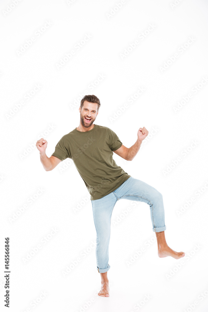 Happy young man standing isolated over white background Happy young man standing isolated over white background