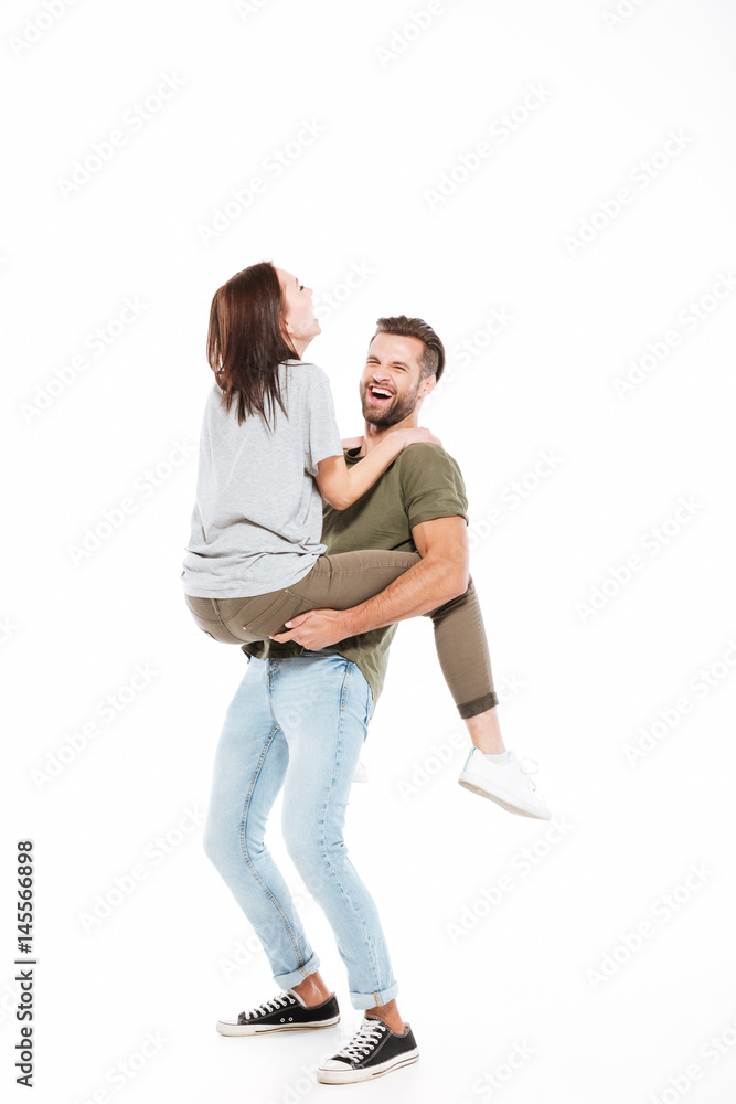 Laughing man holding on hands woman
