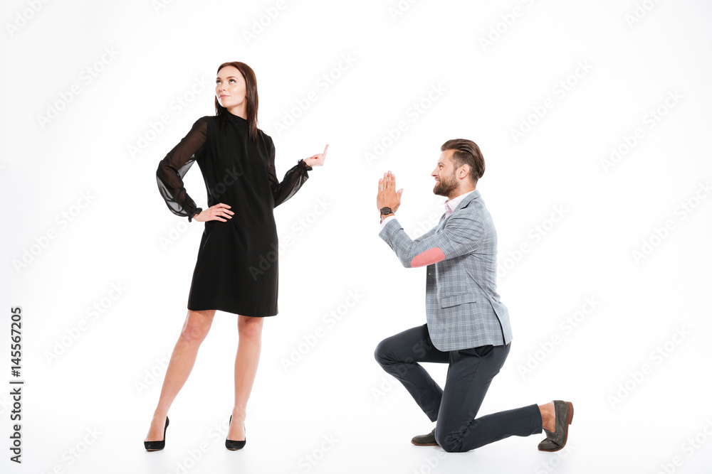 Offended young loving couple standing isolated Offended young loving couple standing isolated